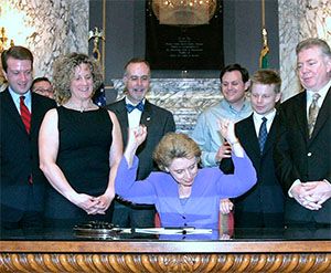 WA Governor Chris Gregoire (center) as she signs the Domestic Partnership Registry Bill alonside Charlene Strong (left).
